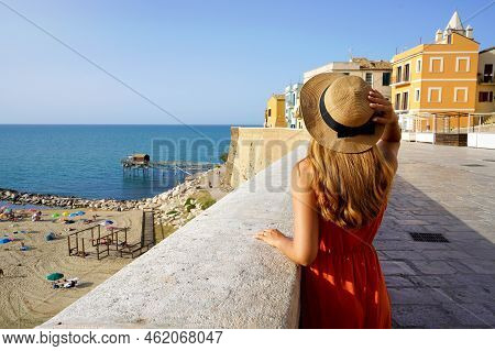 Summer Holiday In Italy. Back View Of Young Traveler Woman Visiting The Old Town Of Termoli, Molise,