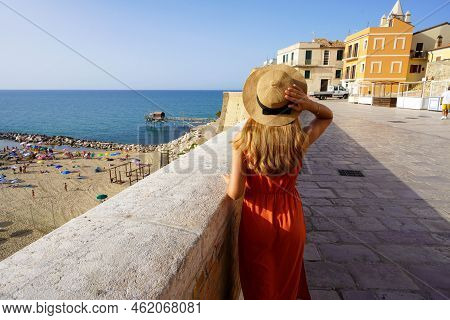 Back View Of Young Woman Walking In The Historic Town Of Termoli, Molise, Italy