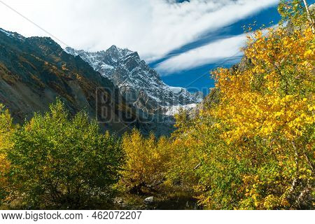 Beautiful Atmospheric Autumn Mountain Landscape On A Sunny Day, In The Distance Chalaadi Glacier, Sv