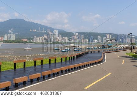 New taipei, Taiwan 08 September 2022: Low tide of the tamshui river with wooden path in Taiwan Bail