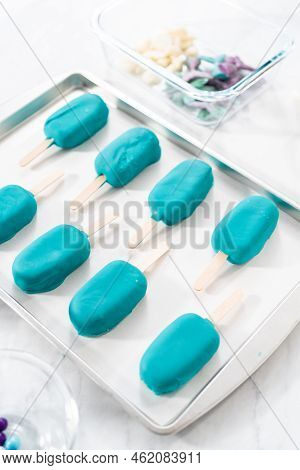 Decorating Cakesicles With Drizzled Chocolate, Chocolate Mermaid Tails, And Seashells.
