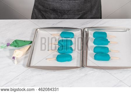 Decorating Cakesicles With Drizzled Chocolate, Chocolate Mermaid Tails, And Seashells.