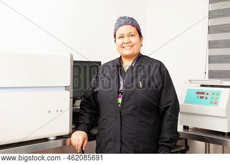 Female Scientist Working At The Laboratory With A Thermal Cycler. Polymerase Chain Reaction Techniqu