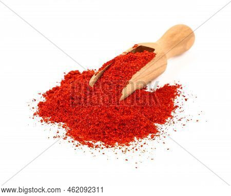 Close Up One Wooden Scoop Full Of Red Chili Pepper, Paprika Or Sundried Tomato Powder Spilled And Sp