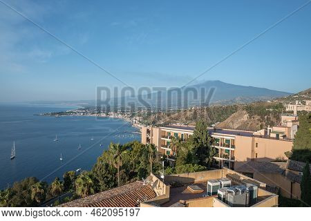 Scenic View Of Hotel Elios And Etna Volcano By Seascape With Sky In Background