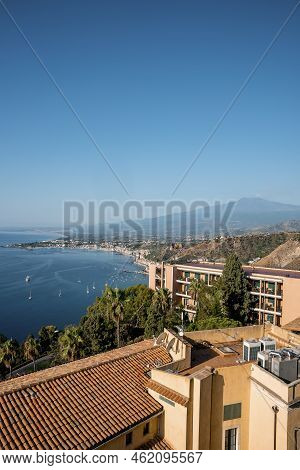 Idyllic Scenery Of Hotel Elios And Mount Etna By Seascape With Sky In Background