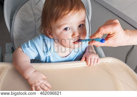 Baby In Highchair Covered In Fruit, Vegetable Puree Close-up. Complementary Feeding Tredhead Oddler 