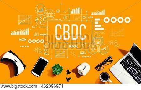 Cbdc - Central Bank Digital Currency Concept With Electronic Gadgets And Office Supplies - Flat Lay