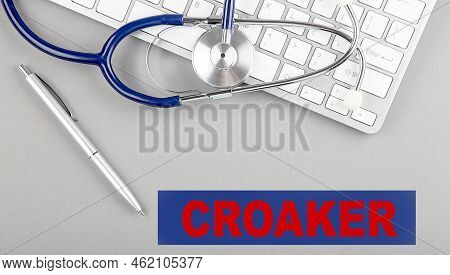 Croaker Word With Stethoscope On A Keyboard On Grey Background