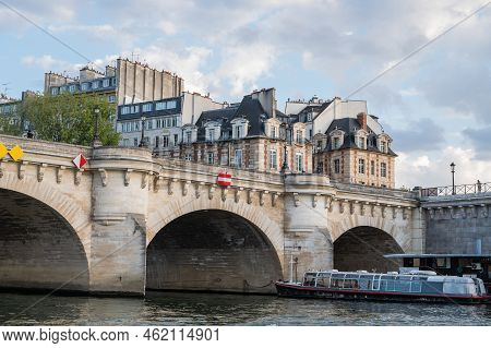 Famous Pont Neuf Is The Oldest Standing Bridge Across River Seine In Paris, France With Grotesk Head
