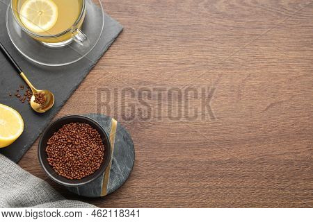 Buckwheat Tea And Granules On Wooden Table, Flat Lay. Space For Text