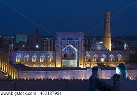 The Old Madrasah Of Muhammad Rahim Khan In The Backlight In The Urban Nightscape. Ichan-kala, Hiva. 