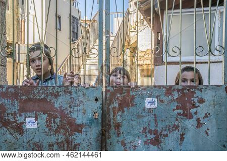 Jerusalem, Israel - July 7th, 2022: Jewish Orthodox Children Looking Out From Behind The Gates Of Th