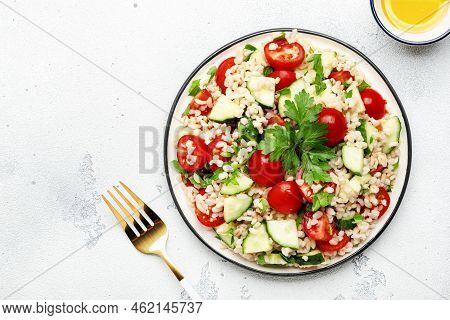 Bulgur Tabbouleh Salad With Fresh Tomatoes, Cucumbers And Parsley. Traditional Middle Eastern And Ar