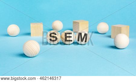 Concept Text 'sem' On Wooden Spheras On A Beautiful Blue Background. Business Concept. Copy Space. S