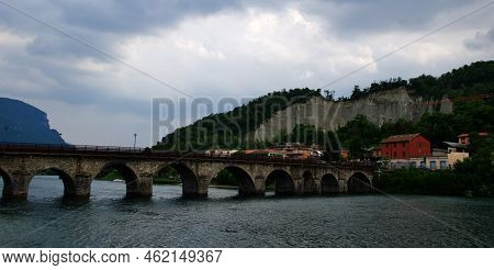 Medieval Bridge Across River Adda In Lake Como, Italy