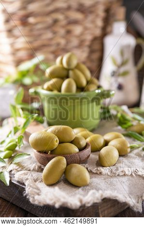 Large Green Olives In A Cup On A Wooden Table. Italian Olives, Sardenya And Greece Harvest. Olive Oi