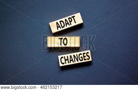 Adapt To Changes Symbol. Concept Words Adapt To Changes On Wooden Blocks. Beautiful Black Table Blac