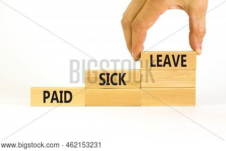 Paid Sick Leave Symbol. Concept Words Paid Sick Leave On Wooden Blocks. Doctor Hand. Beautiful White