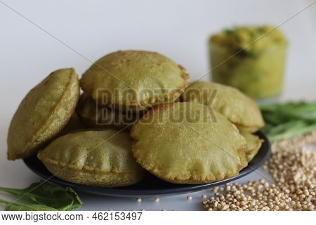 Jowar Palak Puri Or Sorghum Spinach Fried Flat Bread. Fried Bread Made Of Sorghum Millet Flour And P