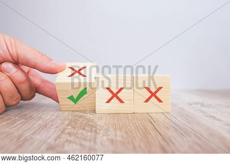 Correct And Incorrect Icons On Wooden Cubes With A Female Hand Choosing The Correct Icon On The Cube
