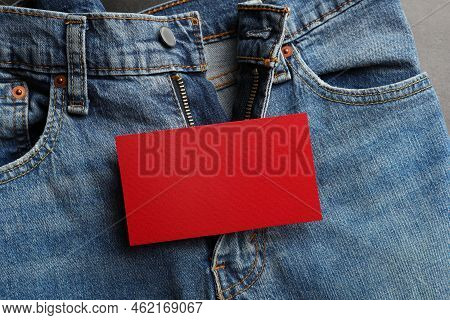 Blue Jeans With Unbuttoned Fly And Red Blank Card On Grey Background, Top View. Exhibitionist Concep