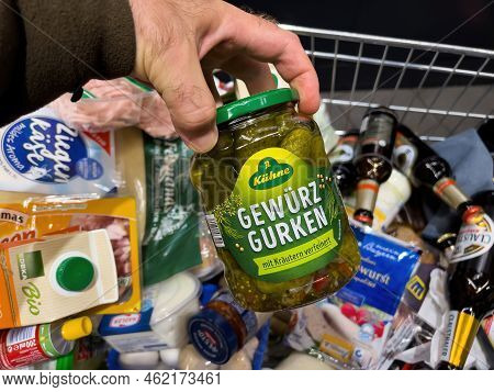 Frankfurt, Germany - Sep 17, 2022: Pov Male Hand With A Full Shopping Cart Of Groceries At A Conveni