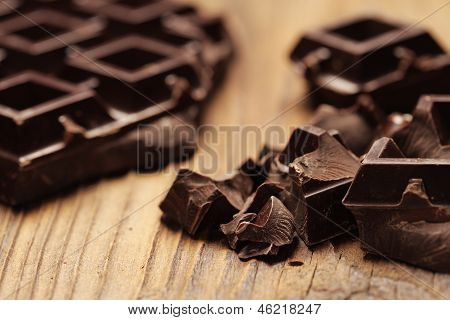 Pieces Of Dark Chocolate  On A Wooden Background