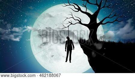 Silhouette Of Man Suicide By Hang Himself On The Tree At Night With Full Moon. Commit Suicide Concep