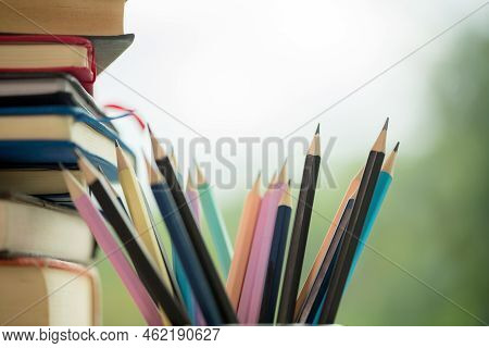 Object Education Green Nature Background With Stack Of Ancient Books Or Old Bible, Open Paper Book O