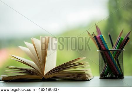 Object Education Green Nature Background With Stack Of Ancient Books Or Old Bible, Open Paper Book O