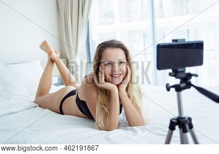Young Sexy Woman Posing In Front Of Camera And Working As Webcam Model