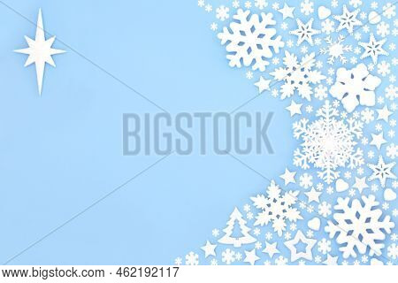 Christmas festive star of Bethlehem and snowflake background border on pastel blue. Fantasy design concept, abstract composition for winter, Xmas and New Year hoilday season.