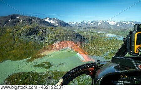 View From Cockpit Of Small Helicopter On Lakes And Mountains In Vast Arctic Landscape. Lakes In Sare