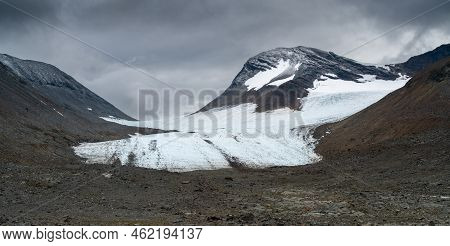 Huge Glacier In Harsh, Remote Arctic Valley On A Cloudy, Rainy Day Of Summer. Basstavagge Pass In Sa