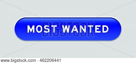 Blue Color Capsule Shape Button With Word Most Wanted On Gray Background