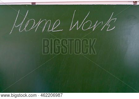 Homework Text On Green School Board. Chalk Writing On The Blackboard.