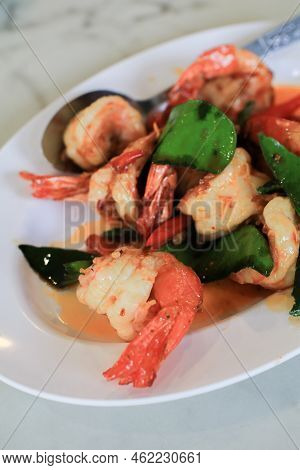 Stir Fried Shrimp Or Prawns With Chili And Kaffir Lime Leaves On White Plate. ฏelicious Thai Food.