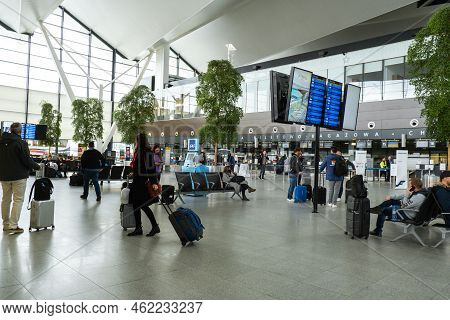 Gdansk Poland - May 2022 Passengers At Gdansk Airport Terminal Waiting For Plane. People Walking To 