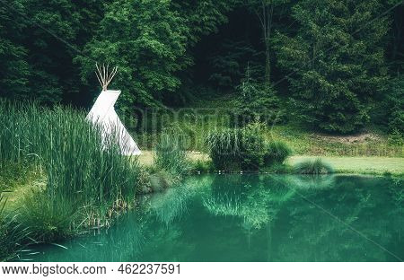 White Teepee Indian Tent Standing In Beautiful Landscape.