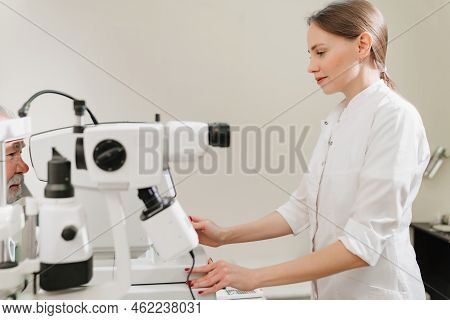 Doctor Examines Eyes On Screen Of Autorefractometer.