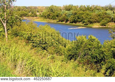 Lush Grasslands And Deciduous Trees On A Hillside Bluff Overlooking The Missouri River Taken At A Ri