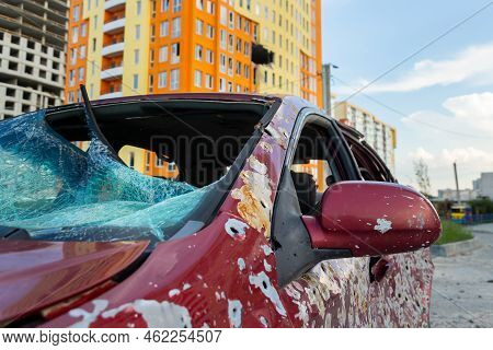Damaged And Destroyed Civilian Car With Shrapnel Holes From Russian Missile In A War Zone In Kharkiv