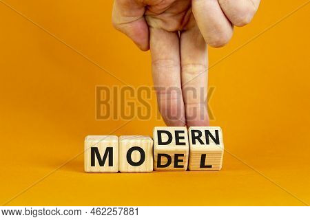 Modern Model Symbol. Businessman Turns Wooden Cubes And Changes The Word 'model' To 'modern'. Beauti