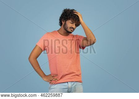 Uspet Indian Guy Touching His Head, Blue Background
