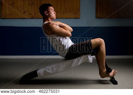 19 Year Old Teenage Boy Doing Situps On An Excercise Bench In A Tank Top