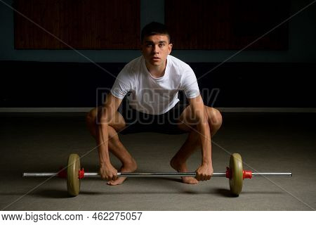19 Year Old Teenage Boy About To Lift A Barbell