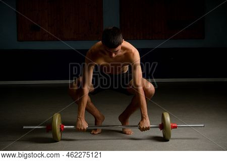 Shirtless 19 Year Old Teenage Boy Lifting A Barbell