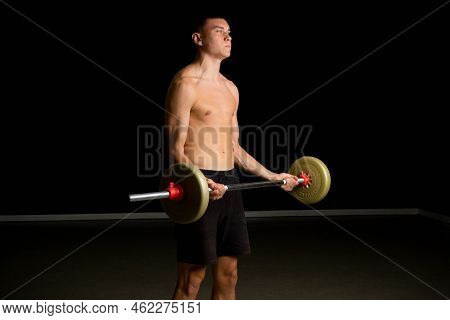 Shirtless 19 Year Old Teenage Boy Excercsing His Bicpes With A Barbell
