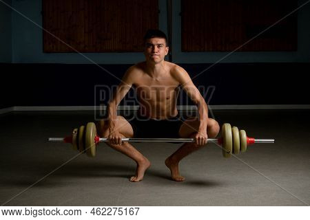 Shirtless 19 Year Old Teenage Boy Lifting A Barbell